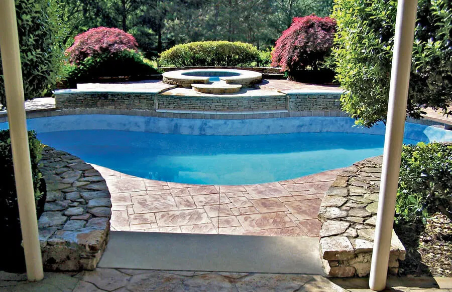 Family-friendly backyard pool with tanning ledge