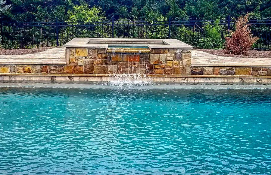 Classic backyard pool with curved coping